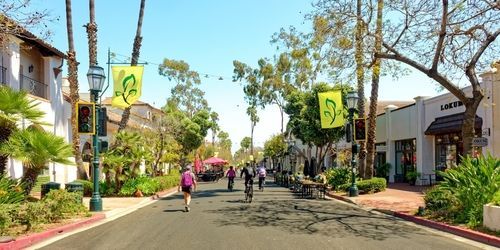 A road in Santa Barbara, CA filled with pedestrians and bicycles. 