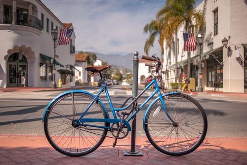 blue vintage bicycle parked and locked to a post in Santa Barbara, CA